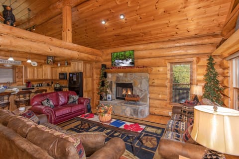 Fireplace and TV in the living room at Great View Lodge, a 5-bedroom cabin rental located in Pigeon Forge