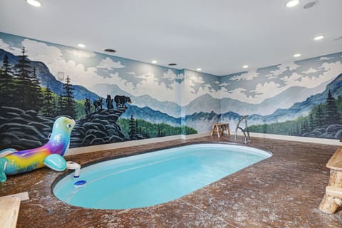 Your private indoor pool awaits, surrounded by stunning mountain murals that transport you to nature's embrace while you swim and relax.