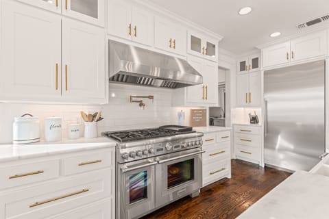 A cozy kitchen with warm lighting, white cabinets, and a welcoming modern touch.
