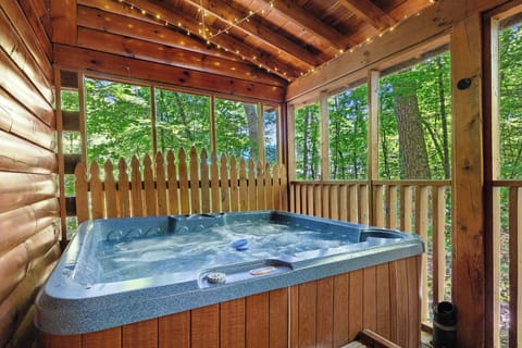 outdoor hot tub with a screened deck