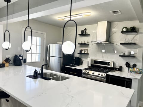 Modern kitchen featuring stainless steel appliances with all the essentials.