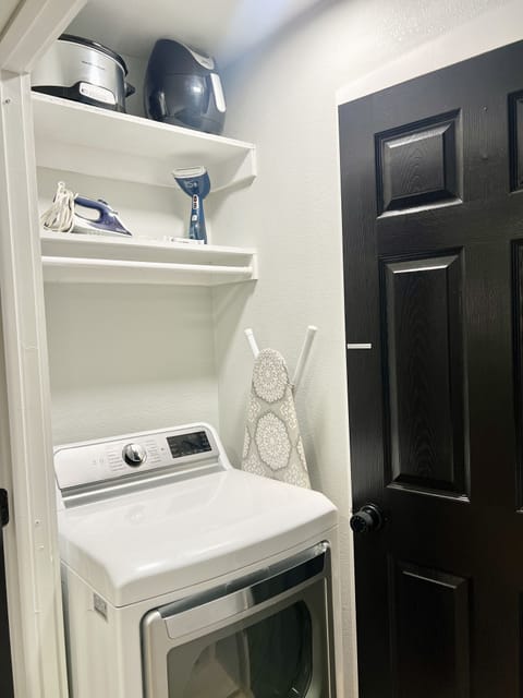 Maytag top-load washer and dryer available to use along with steamer and iron.