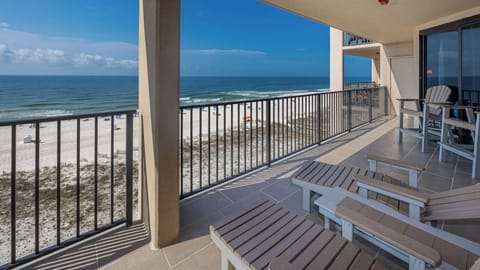 Relax on the spacious balcony with comfortable seating and enjoy the beautiful views of the waves and beach below