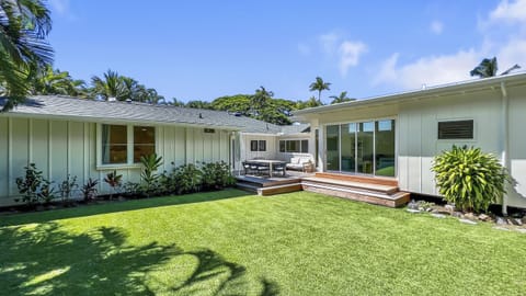 Welcome to your home away from home—framed by lush lawn, native palms, and the peaceful charm of Lanikai.