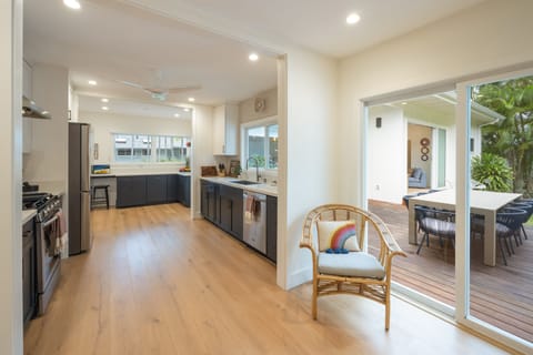 An open layout connects the fully stocked kitchen to the dining area and beyond, creating seamless flow for entertaining.