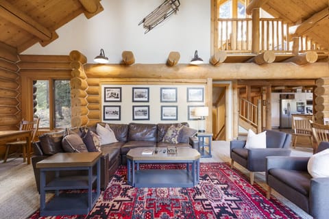 Warm log-style living room with vaulted ceilings.