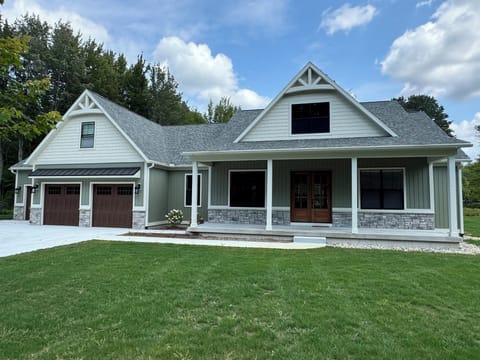 Luxurious home with large driveway, flat yard and 2 car garage with ping pong