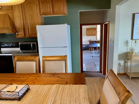 Kitchen and attached garage with ping pong table