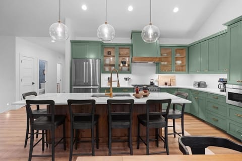 The kitchen boasts an open and expansive layout, allowing for seamless movement and easy interaction. It is flooded with natural light from large windows, creating a bright and inviting atmosphere.