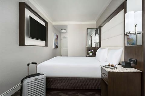 Settle in with luggage space, cozy pillows, and a wall-mounted TV.