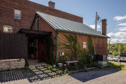 Welcome to the Catskill Cottage! This charming brick exterior offers a cozy, tucked-away feel while being just steps from Main Street.