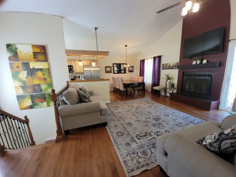 Living room on the main level and stairs to the basement.