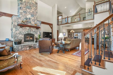 Living Room has Large Stone Wood-Burning Fireplace available for use with Firewood Provided