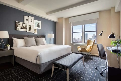 Unwind in a sunlit king room with skyline views.