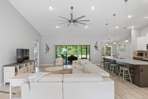 Open-Concept Living Space Featuring Ample Seating and Seamless Indoor-Outdoor Transition