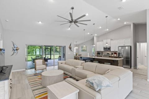 Stunning living space boasts ample seating, expansive windows, and effortless indoor-outdoor living.