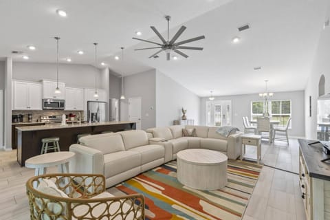 Bright and airy open-concept living room with generous seating area, perfect for socializing.