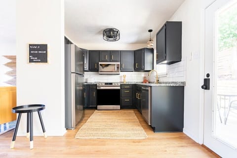 A well-equipped kitchen featuring brand-new appliances and gleaming granite countertops.