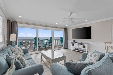 Relax in your coastal living room where ocean breezes flow through sliding doors to your private balcony overlooking endless sea views.