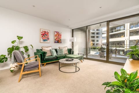 Relax in our stylish lounge room, featuring a chic green decor and comfy seating. The elegant design and plush furnishings create a cosy and inviting atmosphere, perfect for unwinding or entertaining guests in style.
