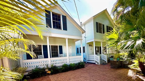 Experience the allure of Key West living in this grand, fully renovated house crafted in the style of Old Key West row houses. The entrance beckons on the right, leading you into a spacious abode.