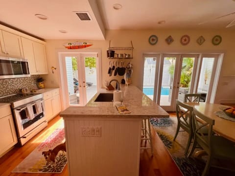 This well-designed space features a sleek kitchen island with three stools.