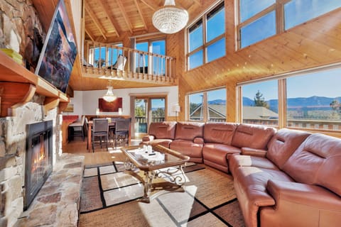 Cozy living room anchored by glowing fireplace, plush seating, and inviting décor perfect for gatherings