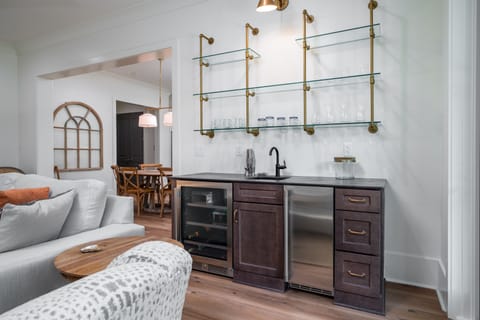 Living room wet bar has a beverage refrigerator and ice maker