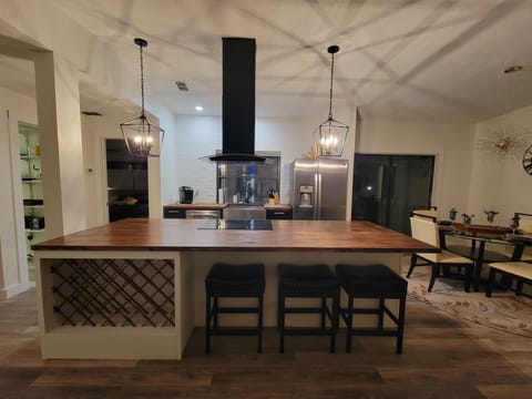 Extra large butcher block island with seating for four and wine cabinet
