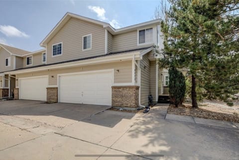 Exterior view of townhome. Corner unit. Attached spacious 2 car garage w openers