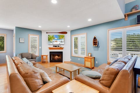 Enter on the Main Level where you'll find a spacious Living Area with comfortable furniture, a large Flat Screen TV, and an electric Fireplace waiting for you.