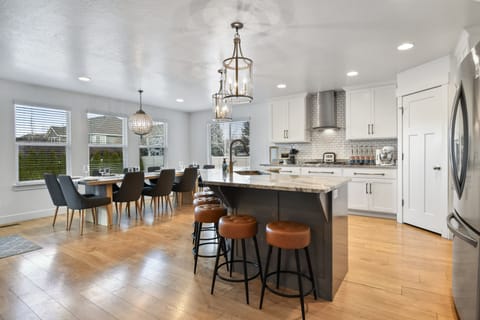 A fully equipped chefs kitchen with massive island that seats 6, plus a dining table that seats 12 for a total of 18 in the kitchen dining area.