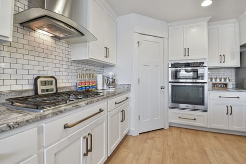 A fully equipped chefs kitchen with massive island that seats 6, plus a dining table that seats 12 for a total of 18 in the kitchen dining area.