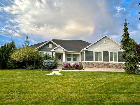 The large grassy mature landscaped front yard of Huckleberry Lane.  Parking on the street for trailers during spring, summer and fall months.