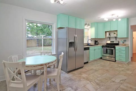 Beachy kitchen fully equipped with dining, utensils and glassware for 8 guests.