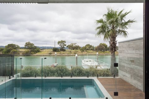 A private swimming pool overlooking the waterfront offers a scenic spot to enjoy a refreshing dip.
