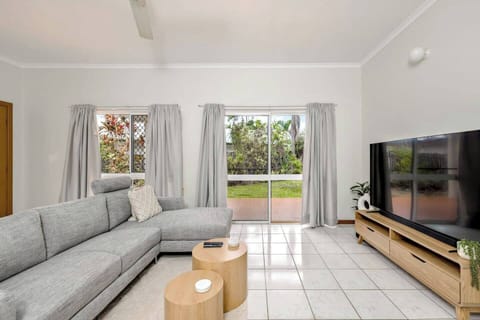The light-filled living room is complete with a sofa, chaise and TV for relaxed movie nights, while split system air-conditioning and ceiling fans ensure year-round comfort. 
