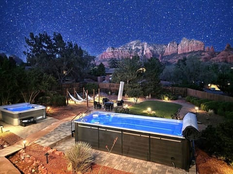 Heated pool and spa with unlimited views to relax on starry night.