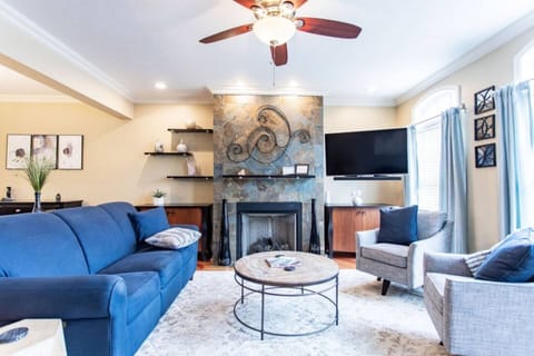 Living room with blue accent décor, complemented by stylish, comfortable furniture that creates a vibrant yet relaxing atmosphere.