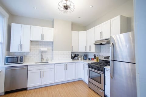 Fully equipped kitchen with modern appliances, including a stove, oven, refrigerator, microwave, and all the cookware and utensils you need to prepare and enjoy your meals.