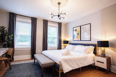 Elegant bedroom with a large window, allowing natural light to fill the space and creating a bright, airy atmosphere for a restful stay.