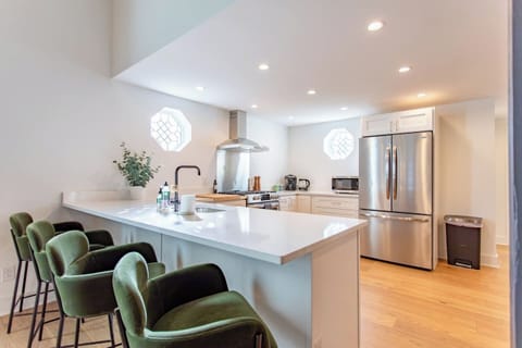 Cozy kitchen diner with a 4-seater table, perfect for enjoying meals or casual gatherings in a comfortable, functional space.