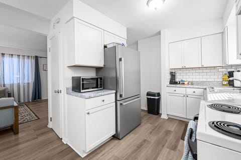 Stainless steel appliances and fully stocked kitchen -- pots, pans, silverware, spices, keriug machine, coffee & tea provided.