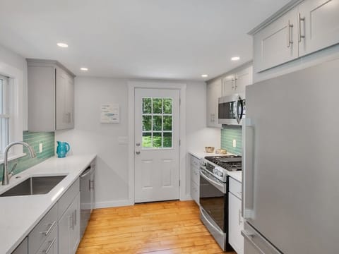 A chefs kitchen with full-sized refrigerator, built-in microwave 