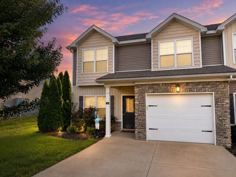 Inviting townhouse with garage, private drive, and beautiful sunset curb appeal