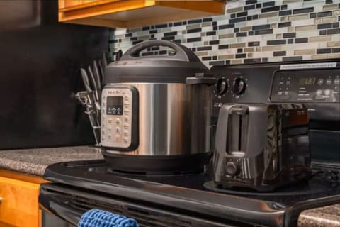 Well‑appointed kitchen stocked with everything you need — Keurig with coffee pods, drip options, double‑basin sink, dishwasher, fridge/freezer, oven, stove, microwave, toaster, and Instapot. Plus, laundry access!