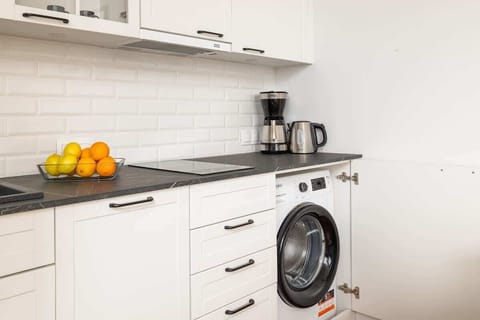 The sleek design of the kitchenette blending seamlessly with the living area.