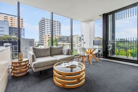 The living and dining area is open plan, with full-length glass creating a connection with the outdoors.
