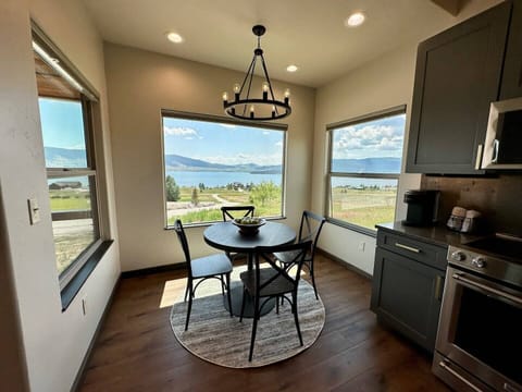 Large windows surround the small dining table, making you feel closer to nature.