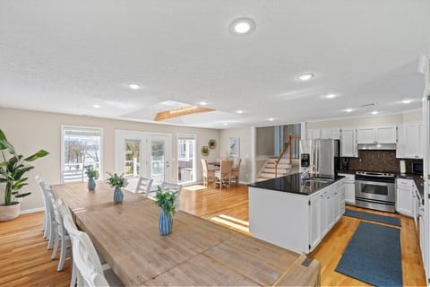 Other vantage point of kitchen showing outside upper deck and 4-top seating table in opposite corner